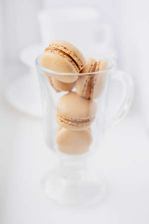 macaroons in a transparent glass. caramel pasta. Light flatley with dessert. Macaroni on white backgroundの写真素材