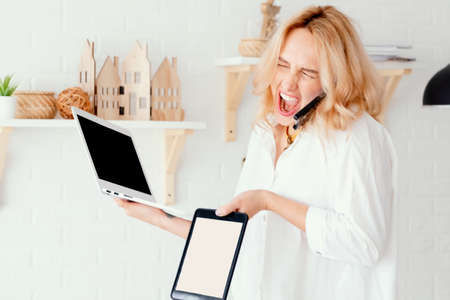 Worried woman making a helpless gesture while working on a project while sitting in an office with a...