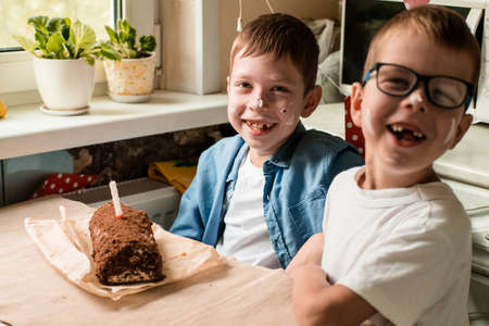 the boys are celebrating their birthday. paraphernalia of children's birthday. Brothers covered with...