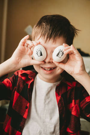funny picture of a boy with eggs instead of eyes. Eggs with painted eyes. Preparing for Easter. Fun...