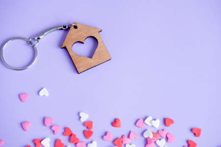 Valentine's day concept many small hearts and keychain on purple background