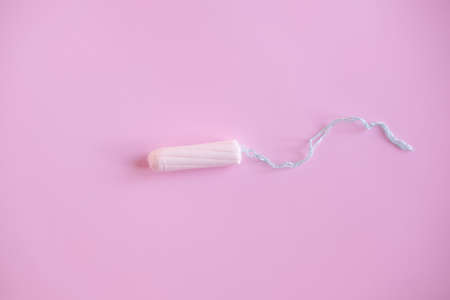 female tampon on a pink background. Hygienic white tampon for women.の写真素材