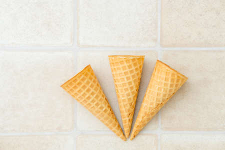 three empty ice cream waffle cones on a white background, top viewの写真素材