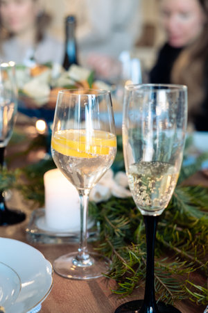 two glasses with alcohol on the New Year's table. glass of champagne and cocktail with lemon in a glassの写真素材