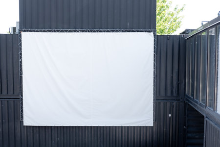empty white screen for showing a movie, on the streetの写真素材