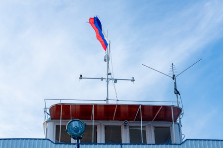flag of Russia over the sky on the roof of the boatの写真素材