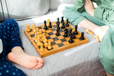 Two children are playing chess close-up. Makes a knight and pawn moveの写真素材