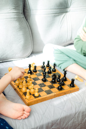 Two children are playing chess close-up. Makes a knight and pawn moveの写真素材