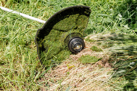 part of an electric lawn mower in the grass, closeupの写真素材