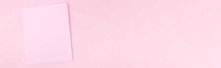 Top view photo workplace with a pink notebook, on an isolated banner pink background, copy space. female business conceptの写真素材