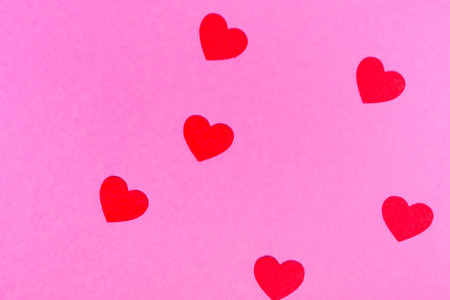 red hearts on a pink background for a greeting card or banner for Valentine's Day.の写真素材
