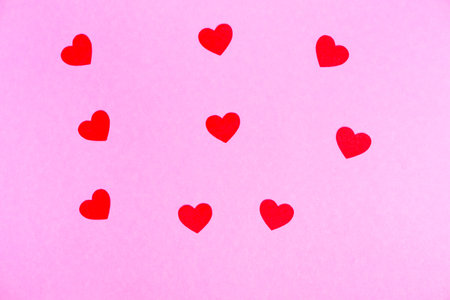 red hearts on a pink background for a greeting card or banner for Valentine's Day.の写真素材