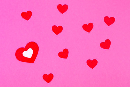red hearts on a pink background for a greeting card or banner for Valentine's Day.の写真素材