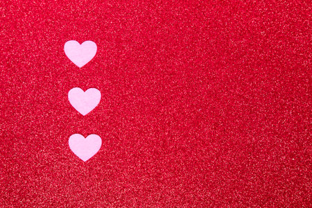 pink hearts on a red background for a greeting card or banner for Valentine's Day, copy spaceの写真素材