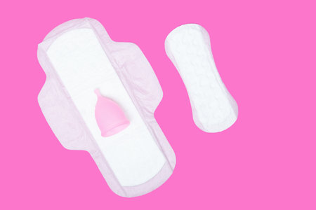 menstrual cup,regular feminine pad and panty liner on pink background,top view. Zero waste concept. Eco-friendly menstrual productsの写真素材