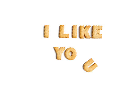 The phrase I like you, made up of cookie letters on a white background. Interesting spelling with...