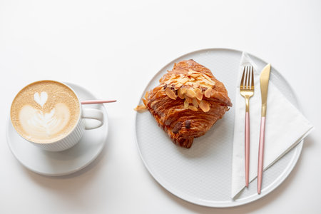cup of coffee with croissant. French breakfast. breakfast on a white background. serving breakfast. coffee snack. croissant with almondsの写真素材