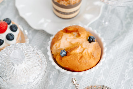 small blueberry muffin on table with white tablecloth, top view.の写真素材