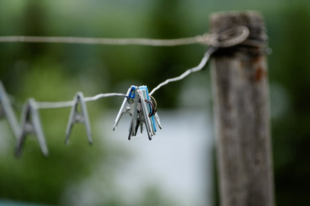 iron clothespins on a rope without clothes on the street, copy spaceの写真素材
