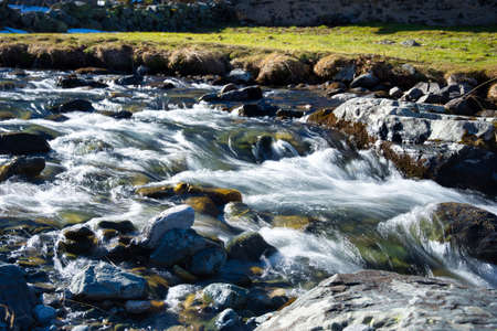 Mountain river flow through rocks and stones long exposure picture at Davos Switzerland