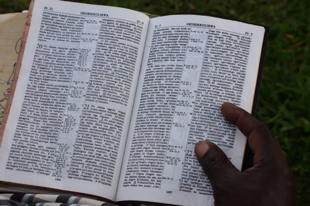 Swahili Bible with hand and finger on the bible from an african menの写真素材