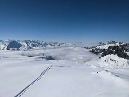 Ski tour in the Swiss mountains. View of the snowy mountains above the clouds. Fantastic views and a...