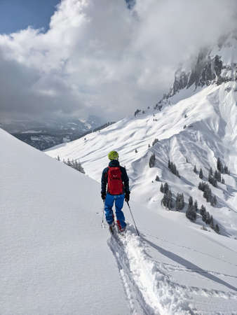 Freerider skiing mountain Silberen in powder snow. Ski tour in the Swiss mountains. Young man enjoys life. Skimo. Viewの写真素材
