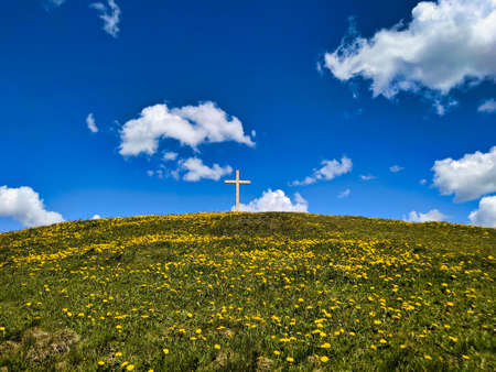 summit cross on the beautiful grass hill huettchopf in zurich oberland switzerland. Wallpaper. Copy Pace. Green fieldの写真素材