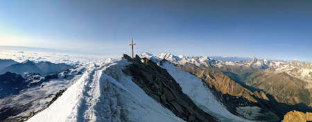 Summit cross on the Dom highest mountain in Switzerland, Mountaineering in the valais alps,...