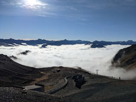 Early morning view from parsenn weissfluhjoch over sea of mist with blue sky, good day for hiking in...