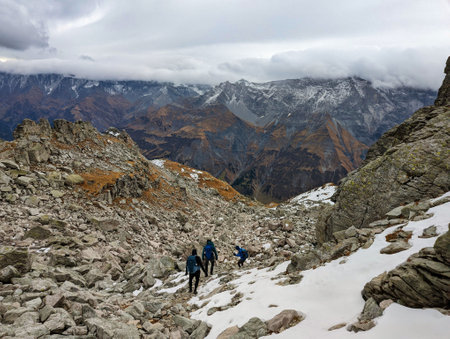 hiking in the old snow in the swiss mountains. Mountaineering on the chli charpf in autumn above elm glarus. Wanderlustの写真素材