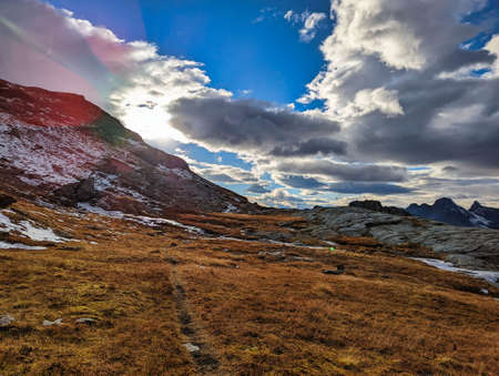 beautiful autumn hike in the beautiful swiss mountains Panorama picture with the first snow.Mountain peaks full of snowの写真素材