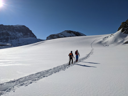 ski touring in deep snow on the glacier. Mountaineering on the Clariden in the Swiss mountains from...