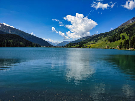 davos lake in early summer. cloudy sky in the mountains. High quality photoの写真素材