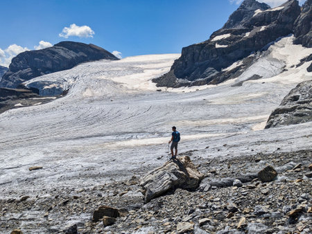 young man enjoys the fantastic view over the glacier. Mountaineering in Switzerland. Claridenfin....