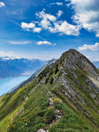 Hiking on the breathtaking Hardergrat in the Bernese Alps. Extremely dangerous path on the mountain ridge. High quality photoの写真素材