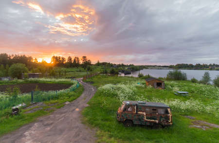 Nice sunset with retro soviet minivan on foregroundの写真素材