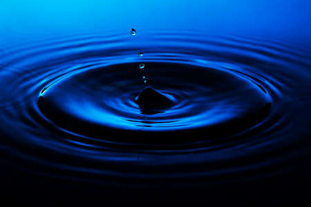 Water drops on dark blue background macroの写真素材