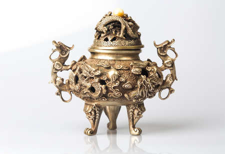 vintage asian style iron vase on a white background with reflection and shadowの写真素材