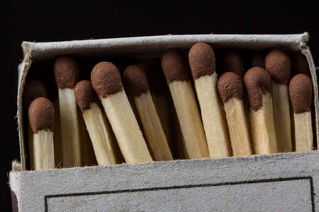 Matches in a box close up on black background