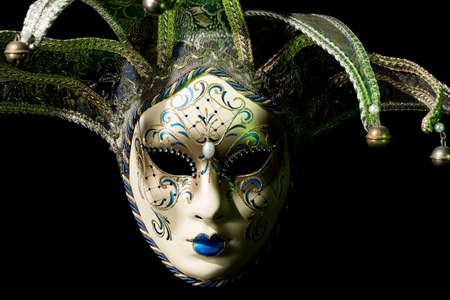 Beautiful venezian souvenir mask with jingles on black backgroundの写真素材