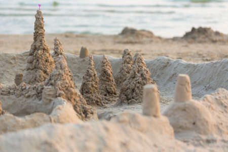 Sand towers city with little heart on the beach.の写真素材