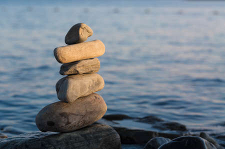 some stones on each other with sea.の写真素材