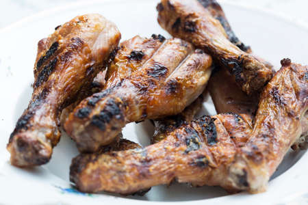 Plate of fresh grilled chicken legs on white background.の写真素材