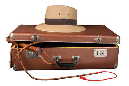 Travel and adventure concept. Vintage brown suitcase with fedora hat and bullwhip isolated on white background.の写真素材