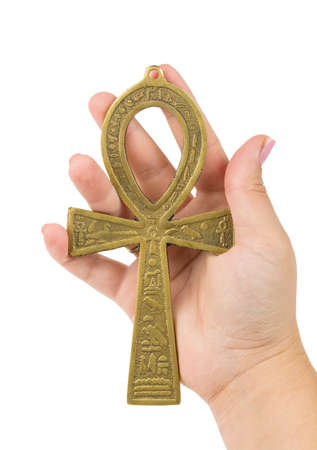 Life concept. Woman's hand holding egyptian symbol of life Ankh isolated on whiteの写真素材