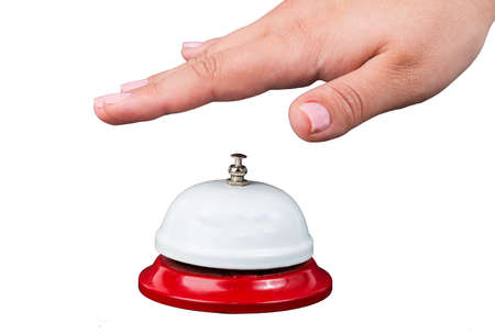 Service concept. Woman's hand above bell isolated on white backgroundの写真素材