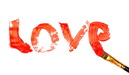 Love inscription made of red paint with brush isolated on white background.の写真素材