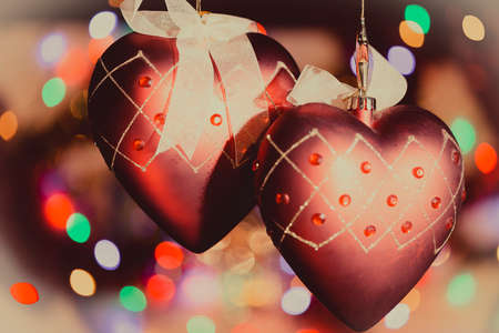 Christmas-tree heart decorations against nice lights background. Nice toned photo.の写真素材