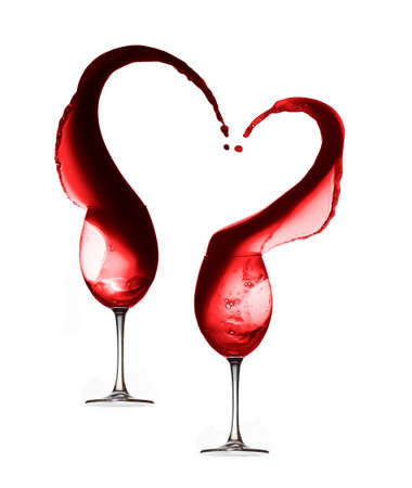 Red wine heart splash with two wineglasses isolated on white background.の写真素材